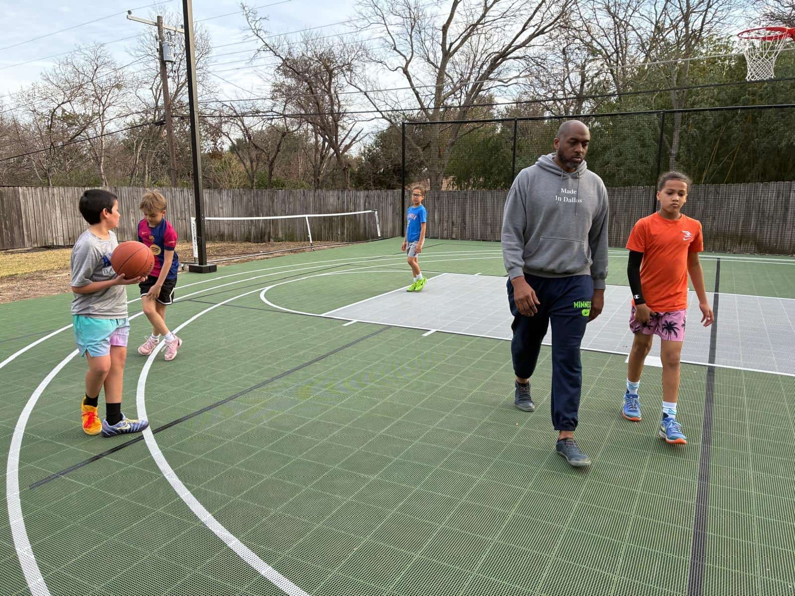 Coach T on the home court with kids